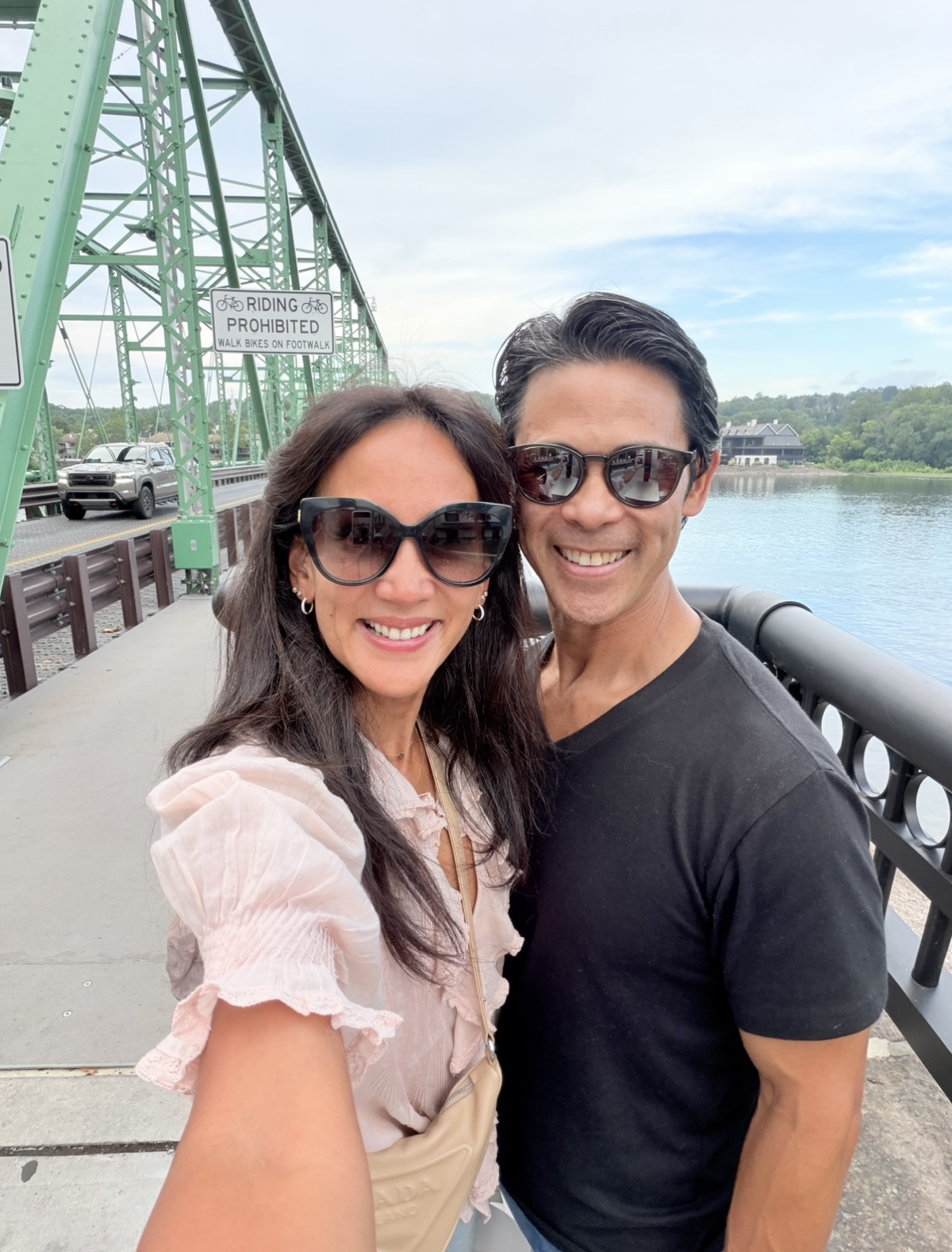 Dr. Valerie Woo and her husband Mike together on a bridge over the river